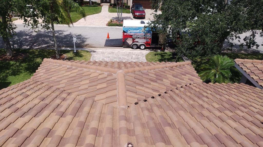 An aerial view of a roof with a truck parked in the driveway.