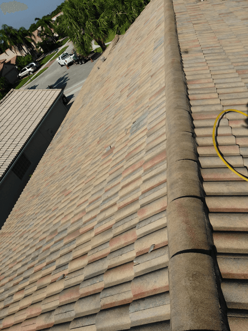 A roof with a yellow hose attached to it