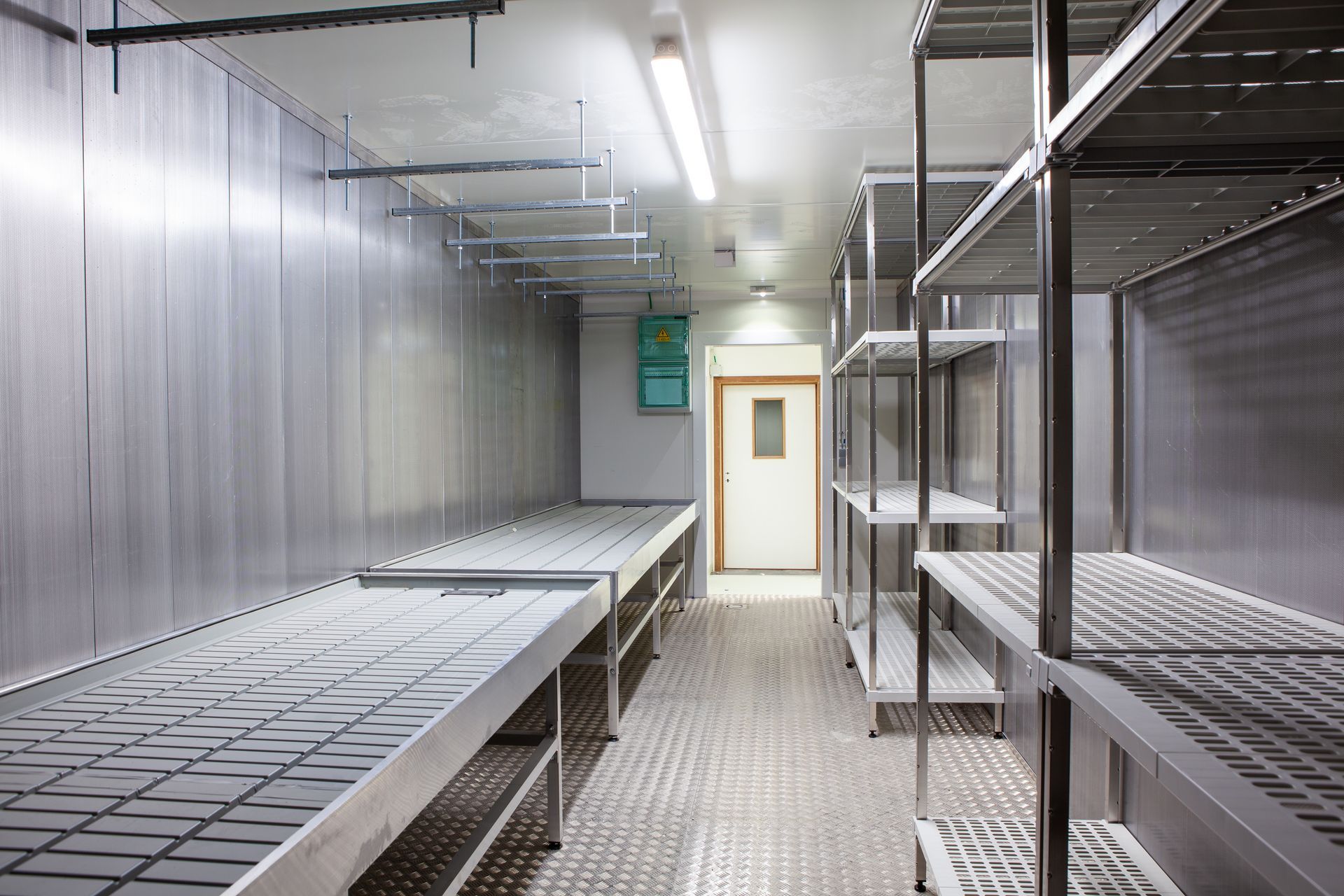 A Stainless Steel Commercial Walk-In Cooler with Shelving and A Door — Gilmour Air & Electrical in Dubbo, NSW