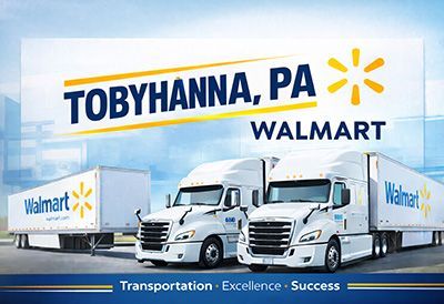 Walmart trucks parked at Tobyhanna, PA, with Walmart branding and Transportation Excellence Success banner