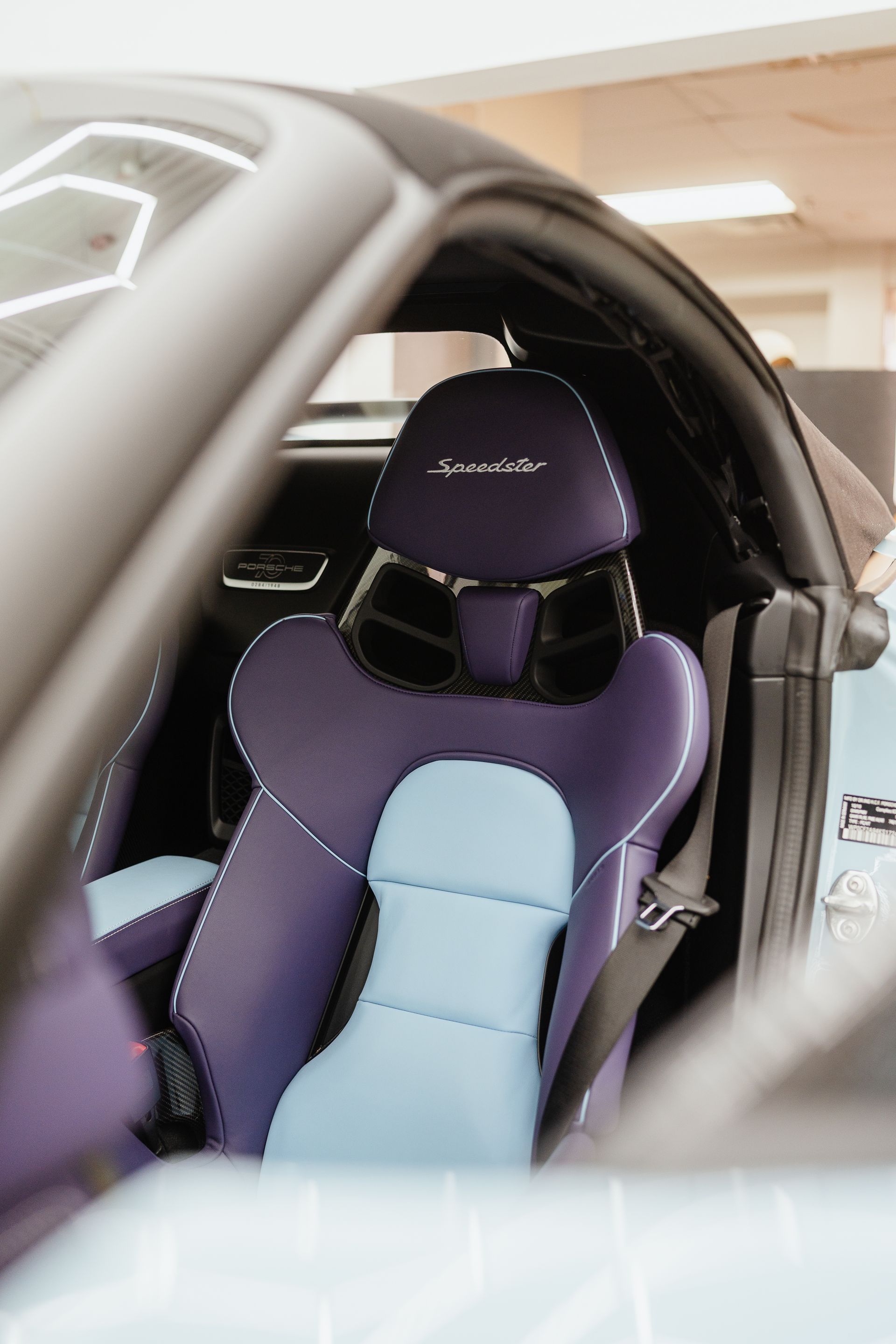 A close up of a purple and blue seat in a car