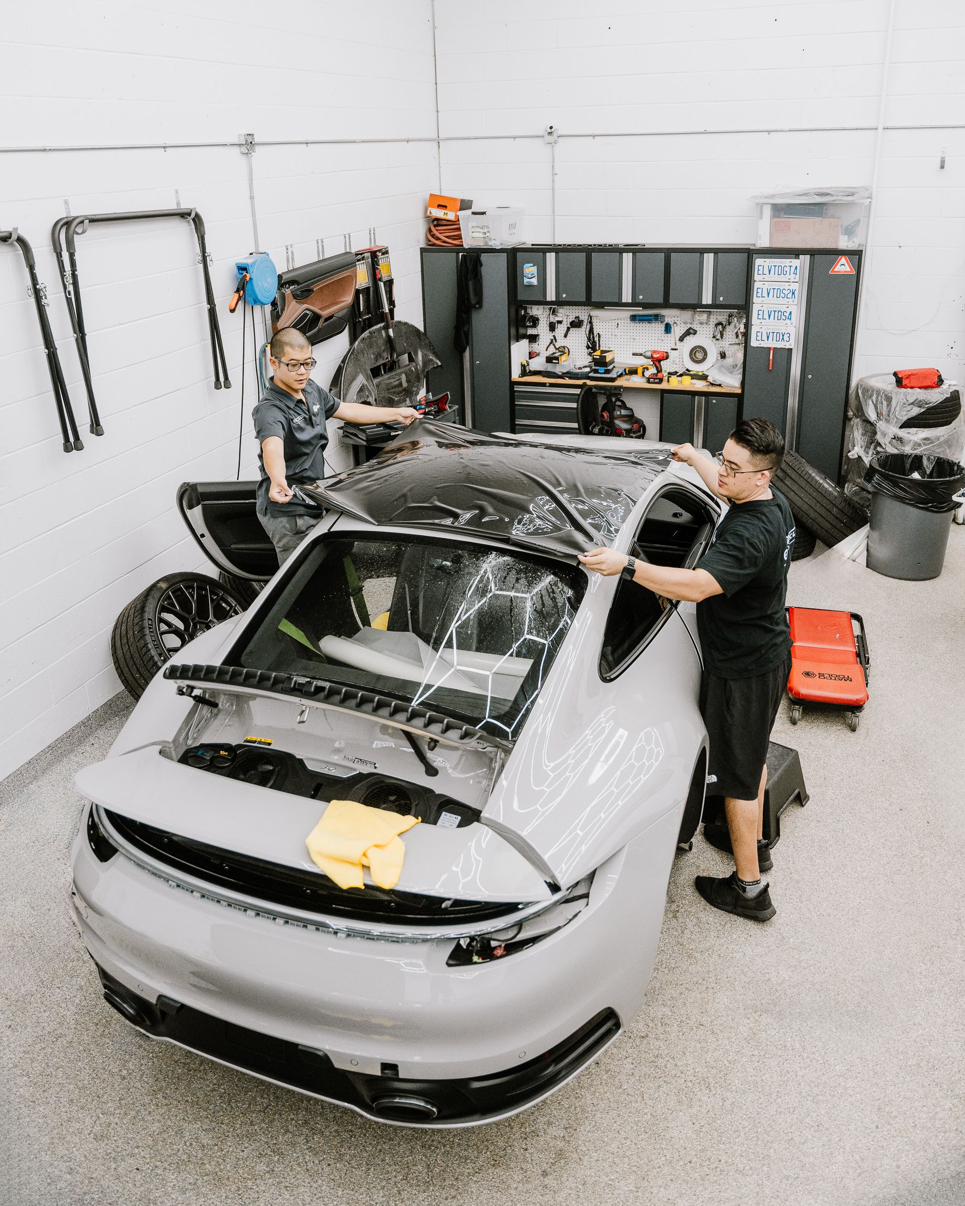 A man is working on a car in a garage.