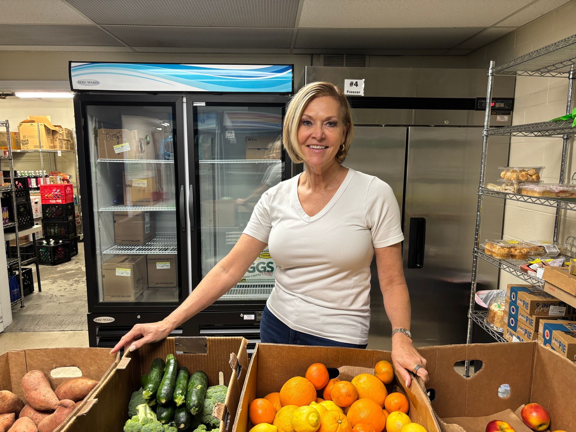 Volunteers packing food donations into boxes at a community distribution center