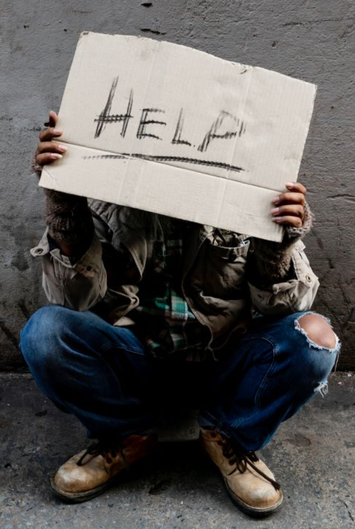 Stacks of canned goods and bagged food supplies on a table, suggesting donation or emergency stockpiling