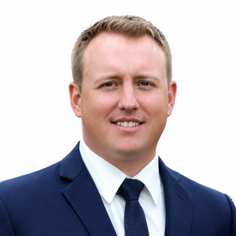 A man in a suit and tie is smiling for the camera.