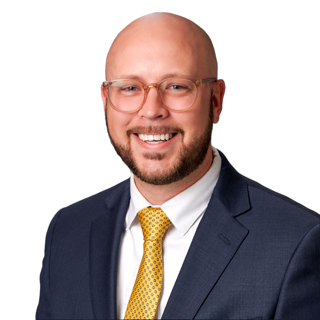 A man in a suit and tie is smiling for the camera.