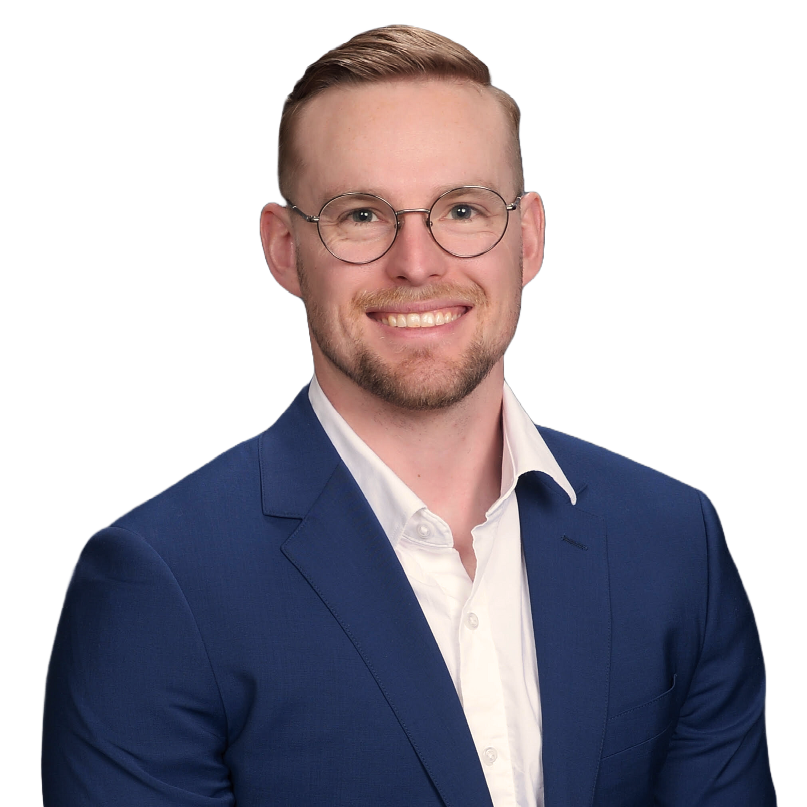 A man wearing glasses and a blue suit is smiling for the camera.
