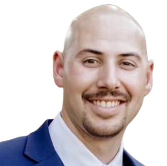 A bald man in a suit and tie is smiling for the camera.