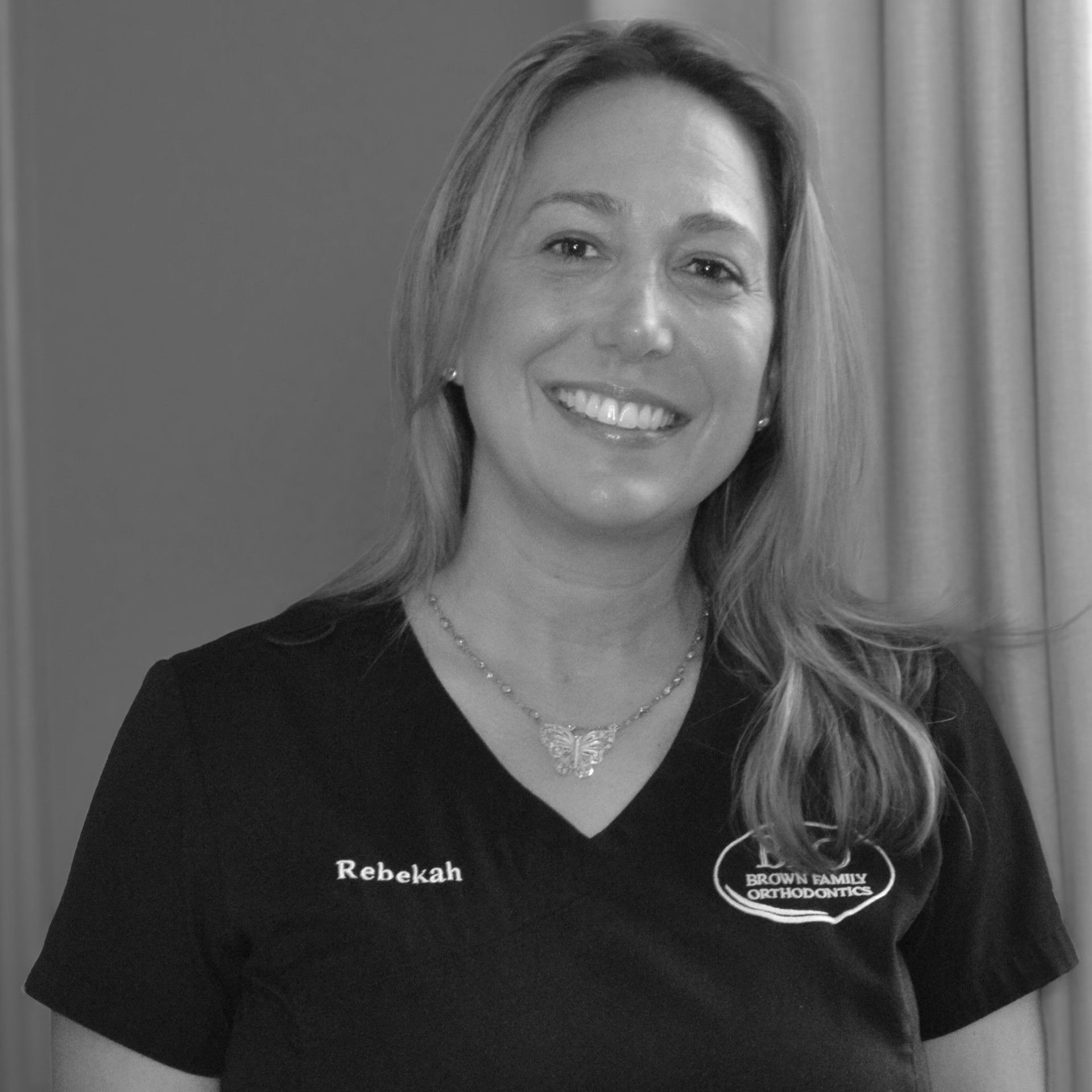 A woman wearing a black shirt that says rebekah treatment coordinator