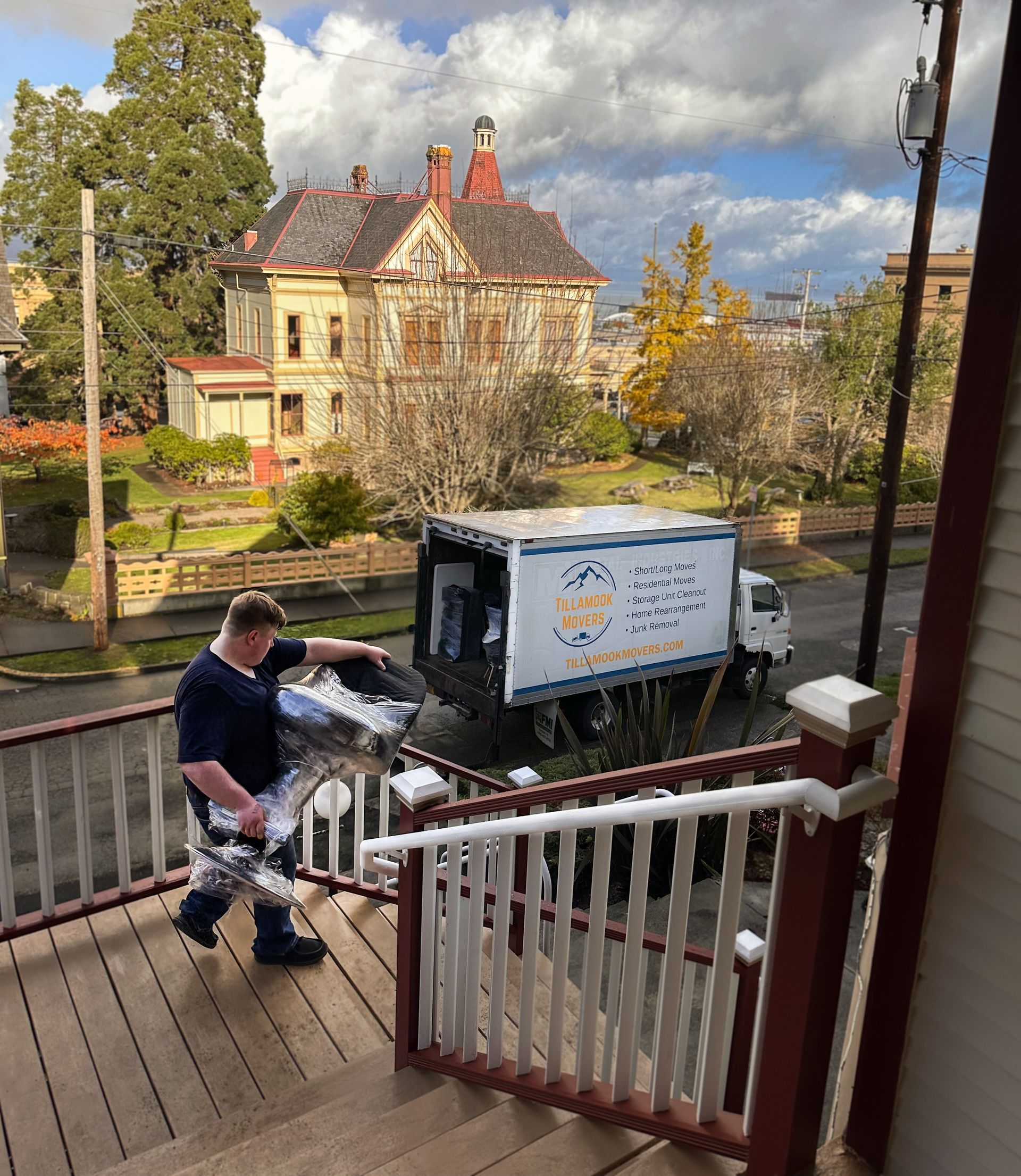 A man is walking down a set of stairs next to a truck.