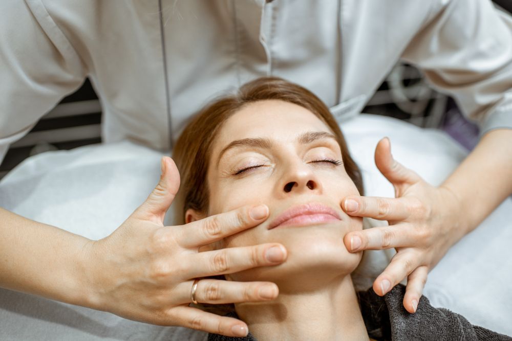 A person receiving a relaxing facial massage from a professional in a spa setting.