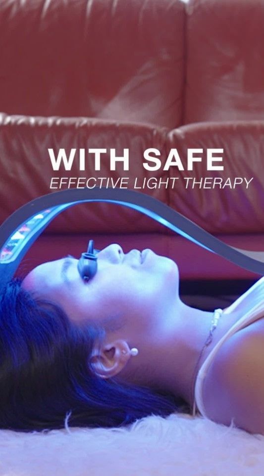 Person receiving blue light therapy with a handheld device, with “SAFE EFFECTIVE LIGHT THERAPY” text overlay