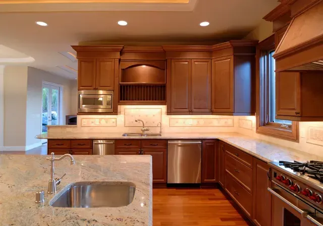 Kitchen with wood cabinets, stainless steel appliances, and granite countertops.