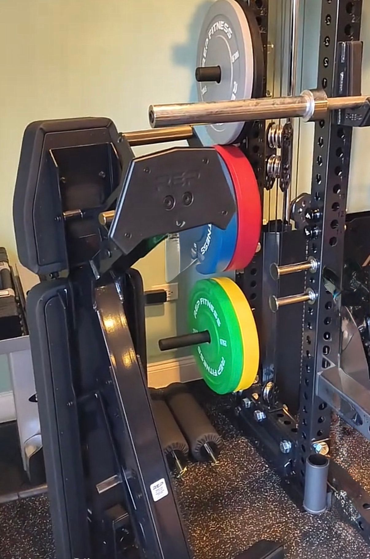Weight bench and barbell rack with weight plates.