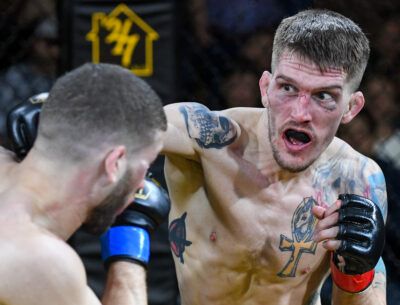 Two men are fighting each other in a boxing match.