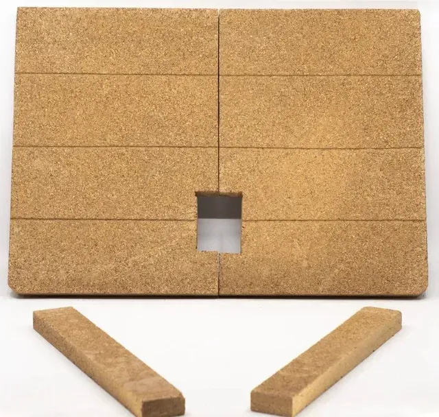 Brown cork board with a square cutout, and two detached cork strips below it