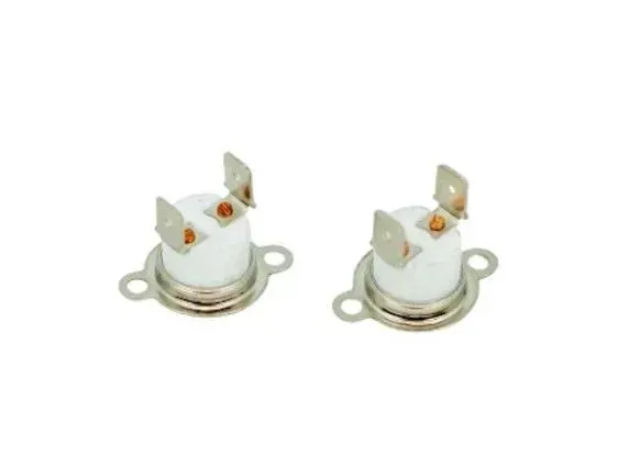 Two white ceramic electrical sockets with brass contacts and mounting tabs on a white background