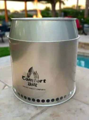 Silver metal ice bucket on a patio table with a Comfort Suites logo.
