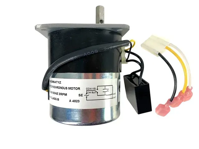 Black electric motor with attached wires and connectors on a white background