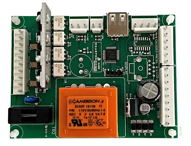 Green circuit board with orange relay, connectors, and electronic components