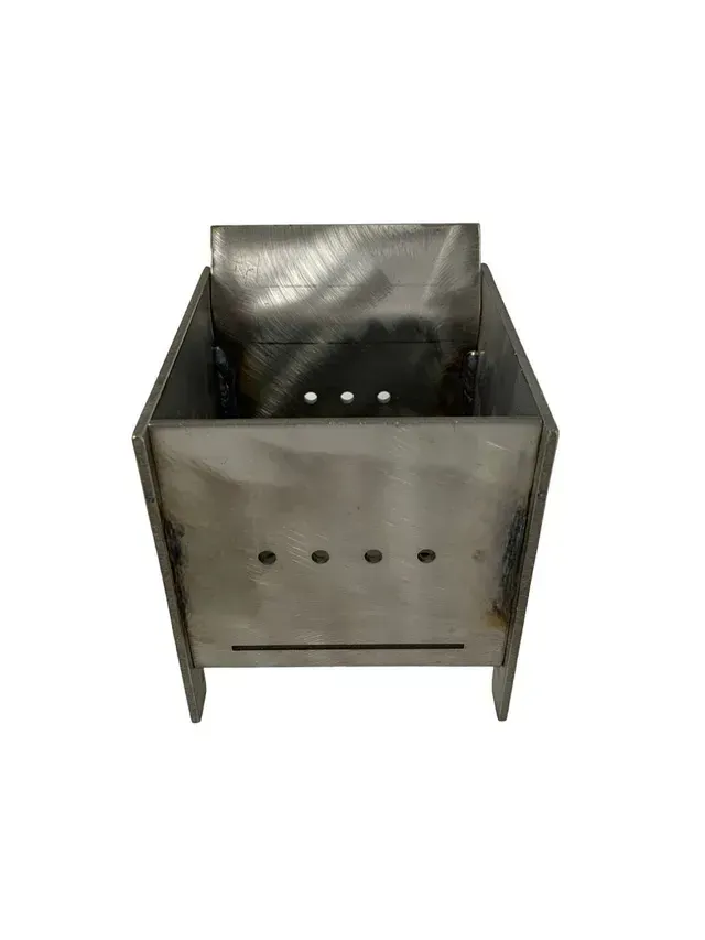 Metal charcoal grill with a perforated front panel and open top on a white background