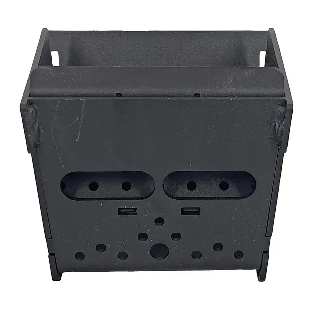Black metal device front panel with slots and holes on a white background