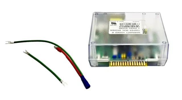 Electronic control module with attached green and red wires on a white background