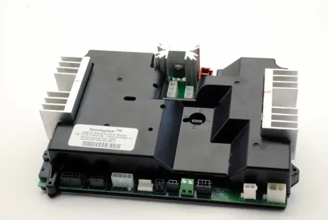 Black electronic circuit board with silver heatsinks and multiple connectors on a white background