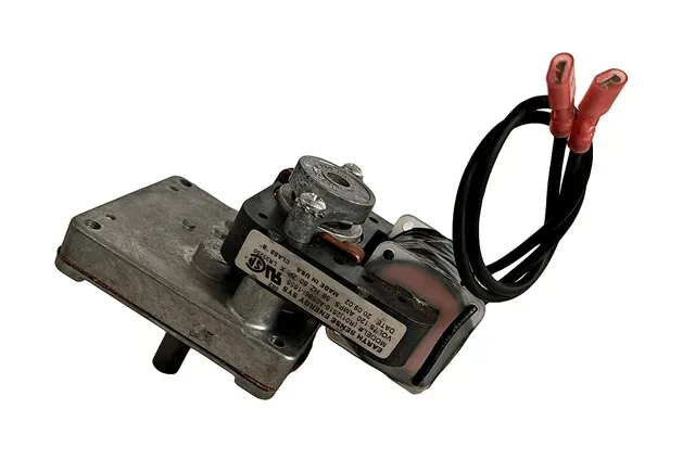 Small black-and-metal electrical switch assembly with red and black wires on a white background