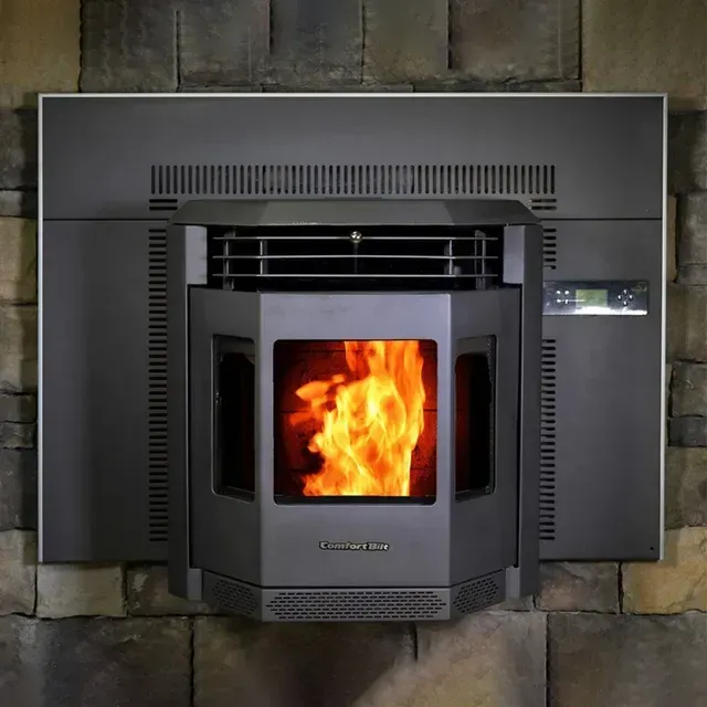 Modern fireplace insert with a bright orange fire built into a stone wall
