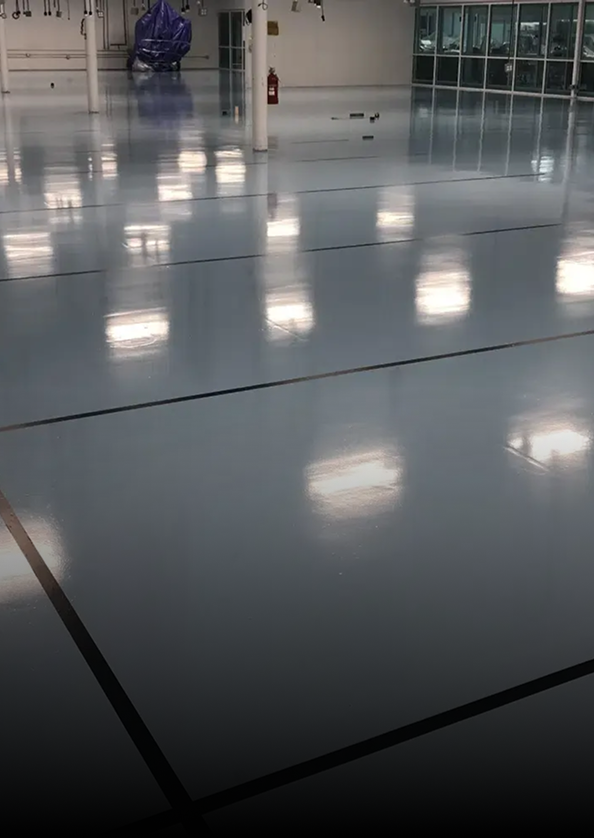 Empty glossy indoor floor with ceiling light reflections in a modern lobby