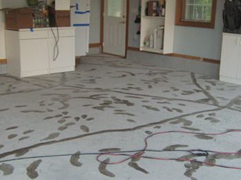 Empty room with patterned floor covering, cabinets, and an open doorway