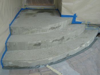 Concrete steps under construction with blue tape marking edges