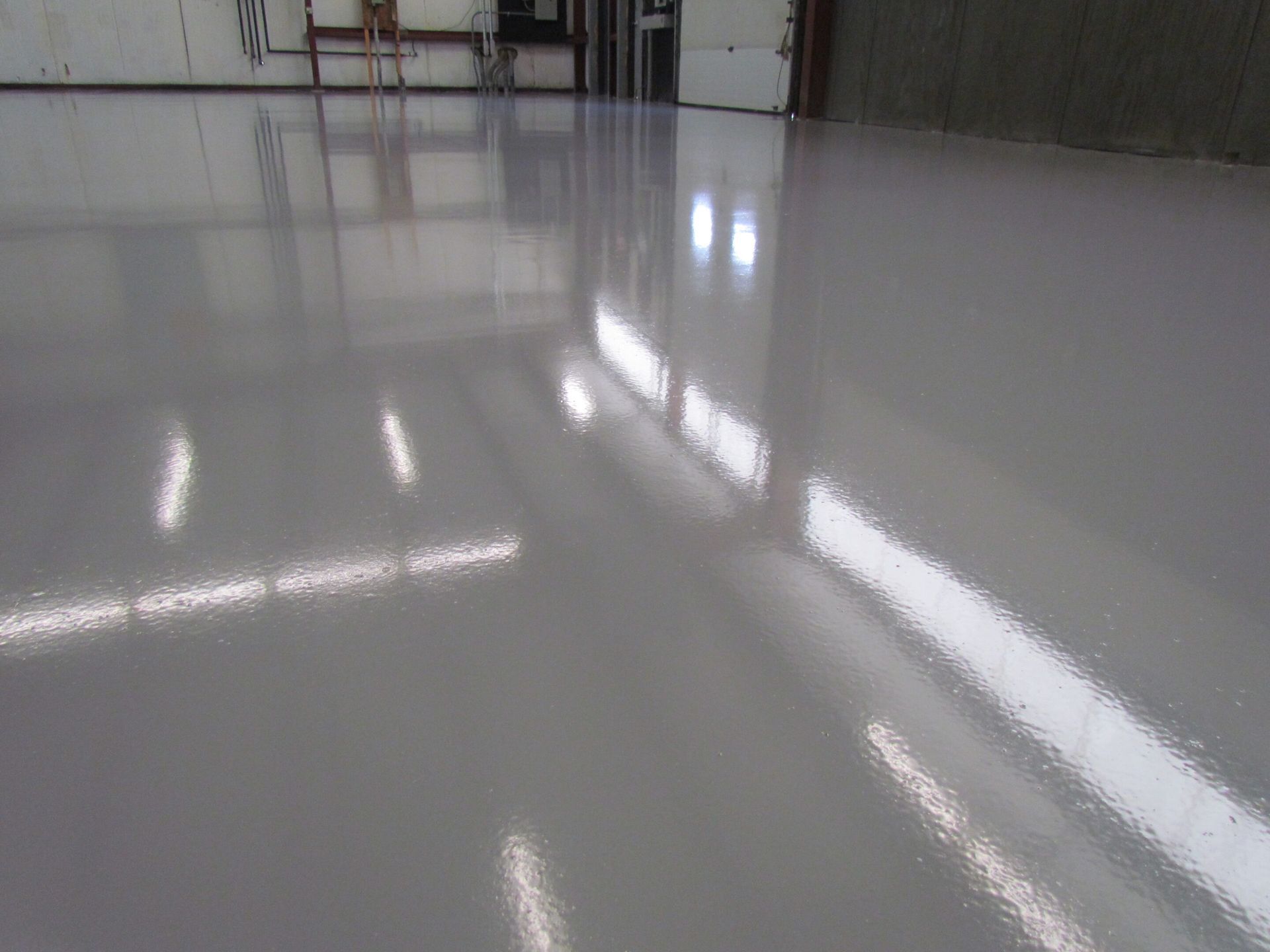 Shiny white tiled floor reflecting window light in a room