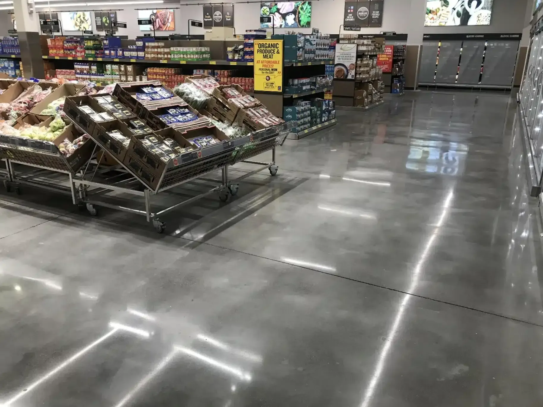 Grocery store produce section with neatly stacked vegetables and shiny polished floor