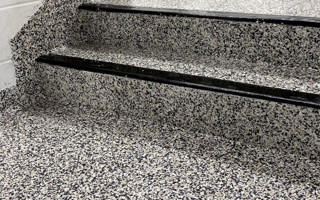 Granite stairs with a black anti-slip strip along the edge of one step