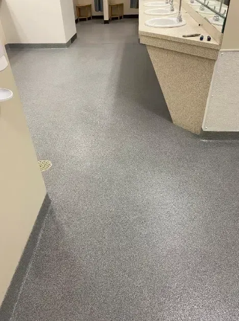 Empty clinic hallway with gray flooring and beige counters