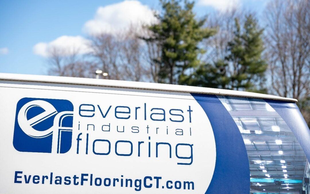 A van displaying the Everlast Industrial Flooring logo and website