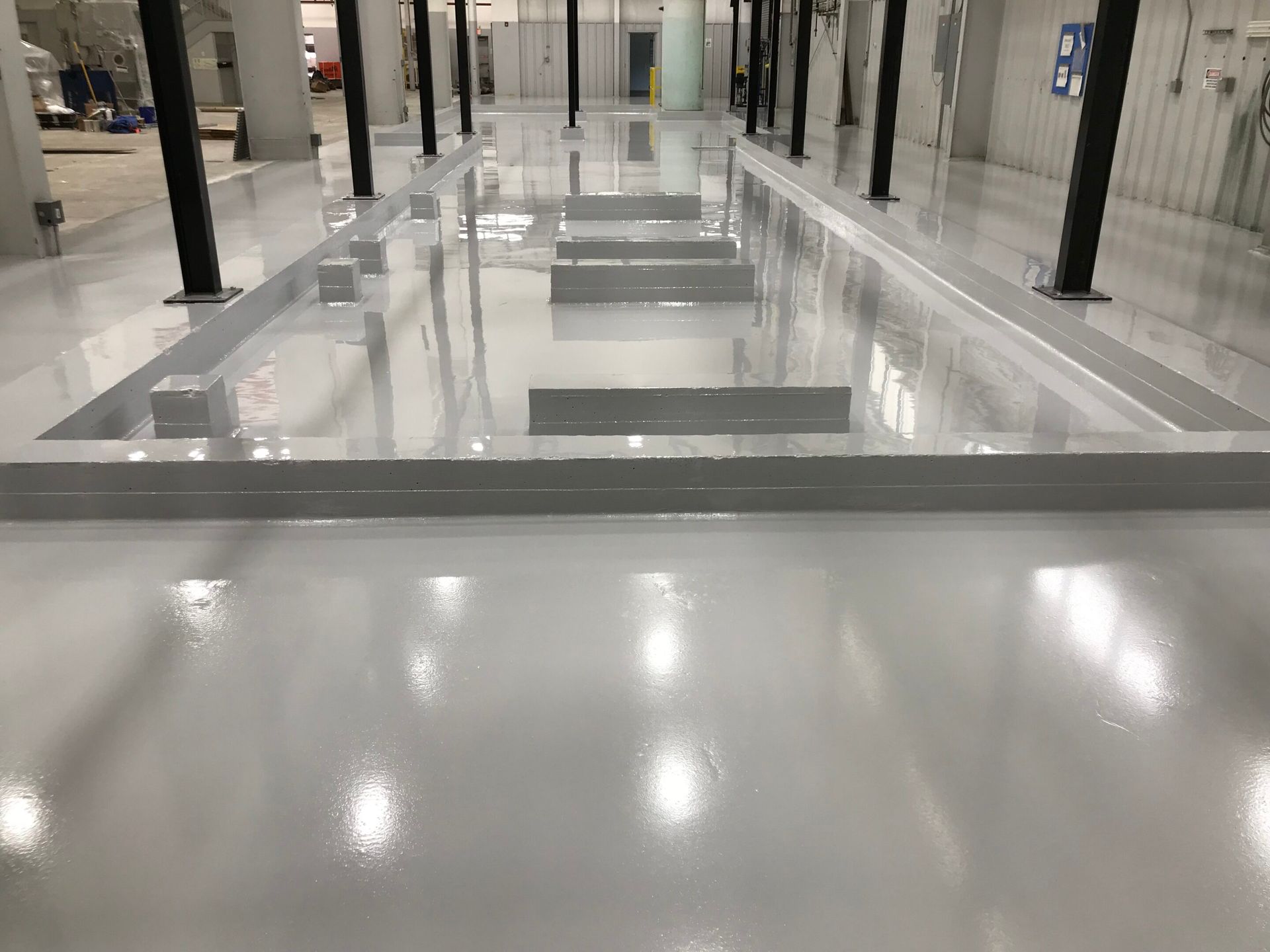 Empty polished mall corridor with shiny floor and columns, viewed from a raised walkway
