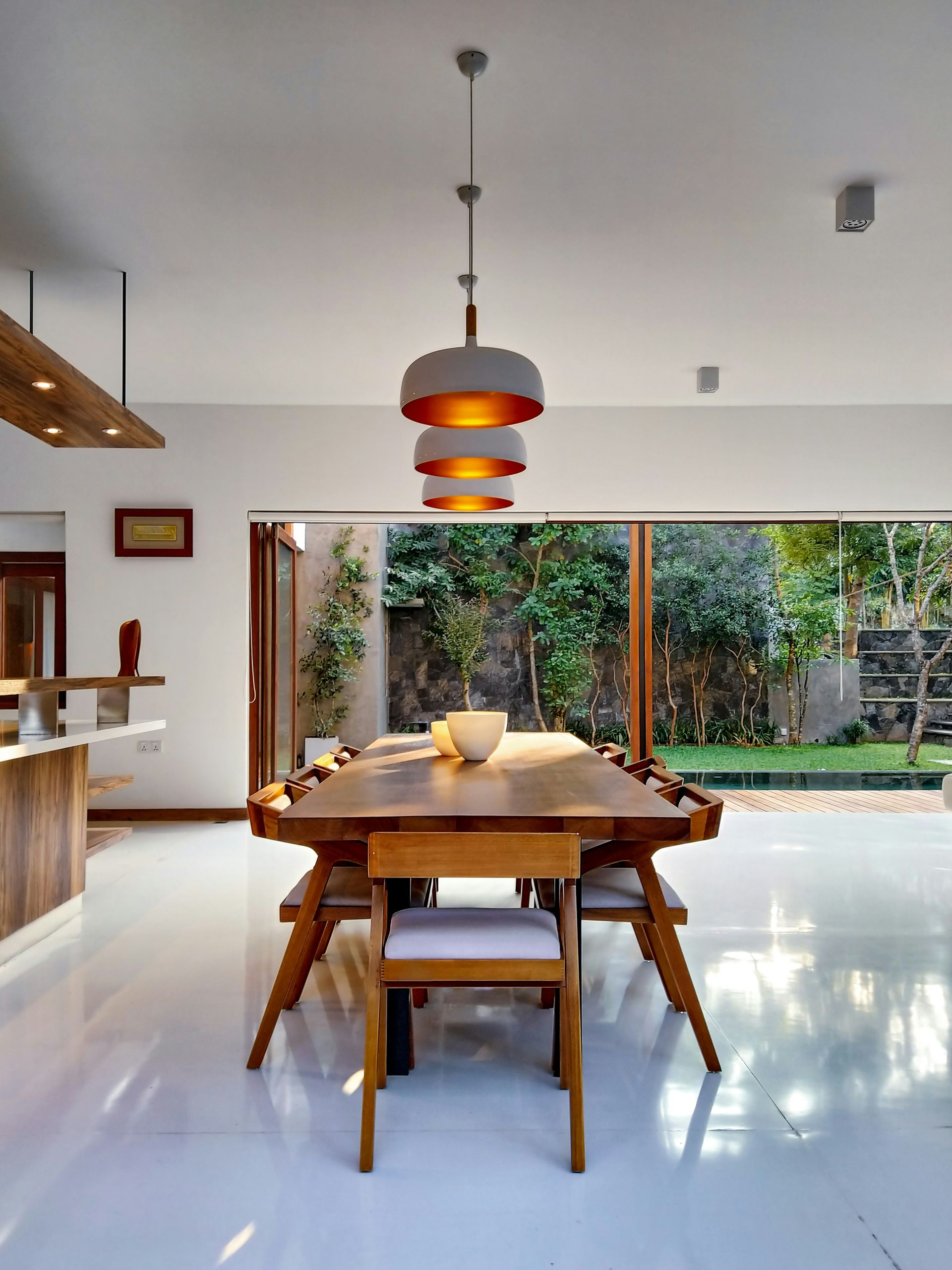 A dining room with a long wooden table and chairs — The Home Assembly In Avoca Beach, NSW