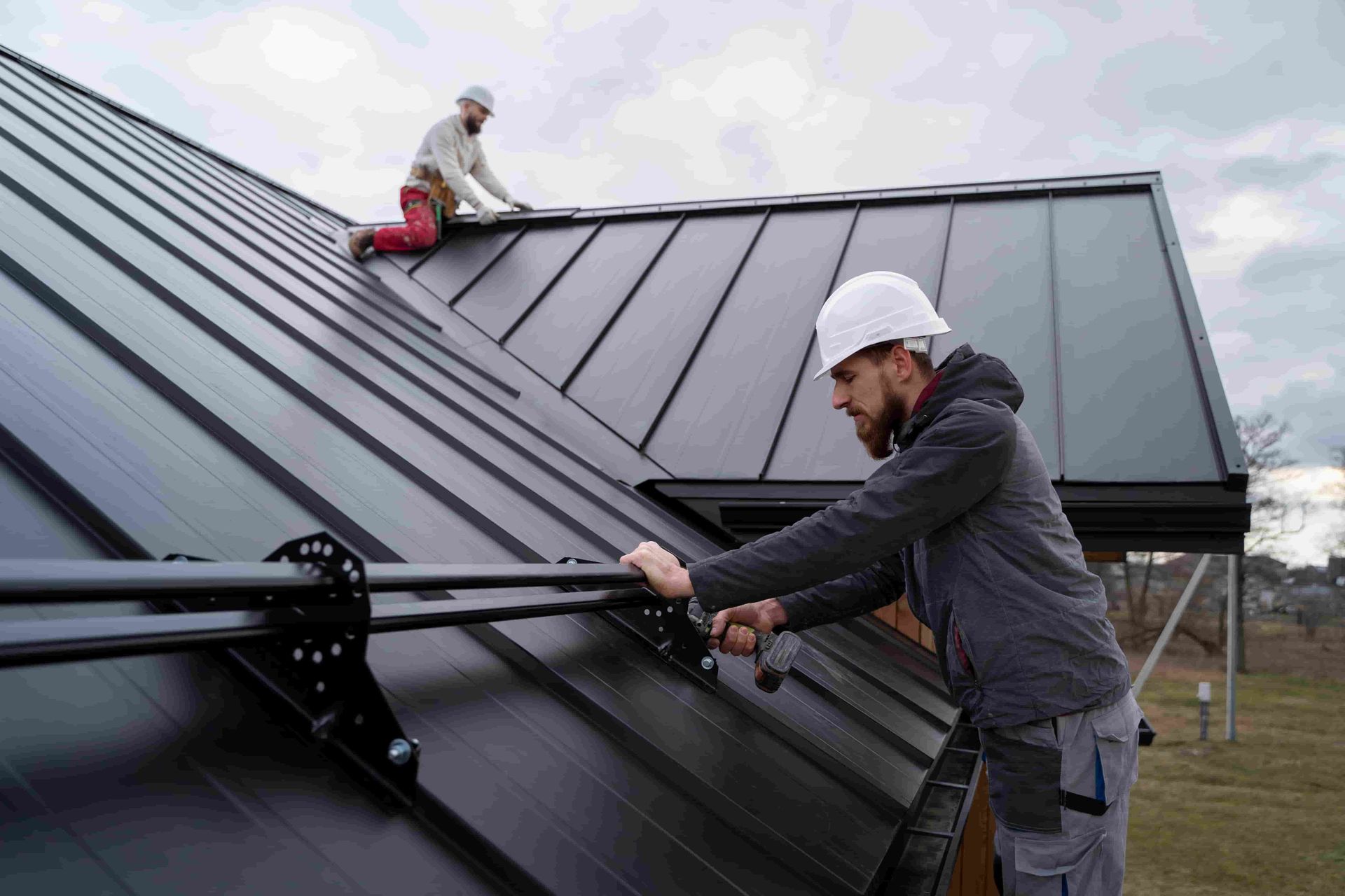 Men Working On Roof Together — Elliott Timber Sales Pty Ltd in Ryan, QLD