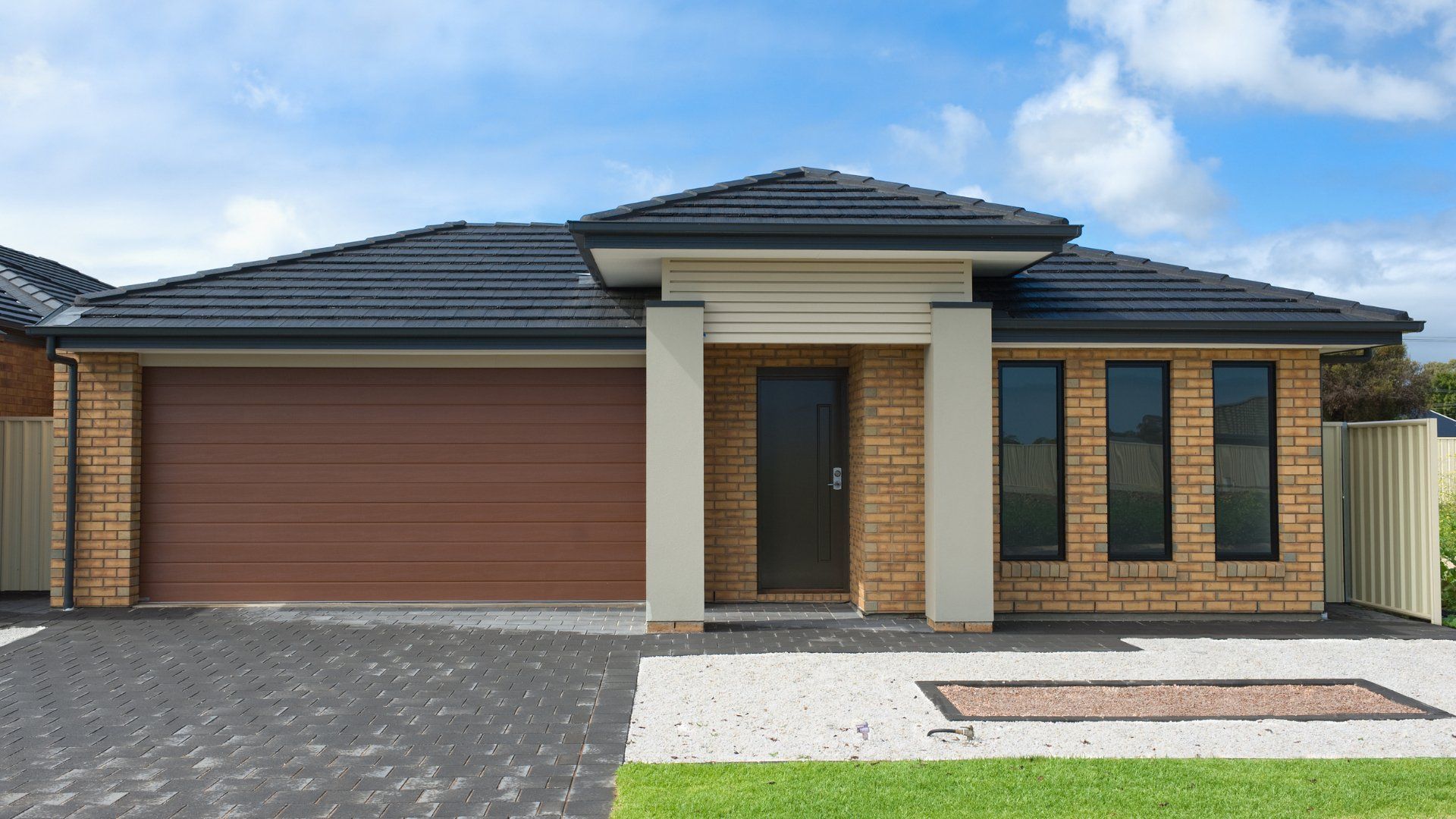 Concrete driveway with concrete stamp designs in front of a house.