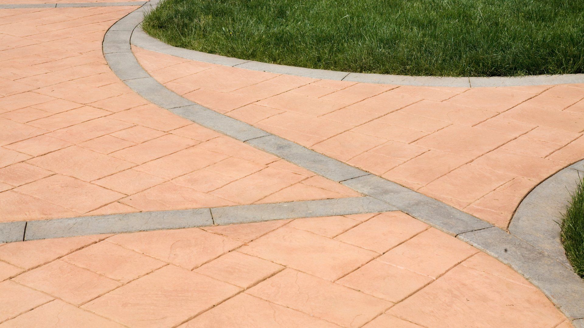 This is a picture of a stamped concrete patio in a backyard.  The concrete is a beige colour with a grey border.  The second picture is of a stamped concrete walkway.  The third picture is of a freshly poured concrete slab on grade.  The fourth picture is of textured and colored concrete.  The fifth picture is of a new concrete driveway.  The sixth picture is of a concrete pool deck.