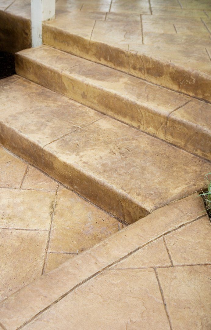 Closeup picture of concrete steps leading up to an outdoor patio.