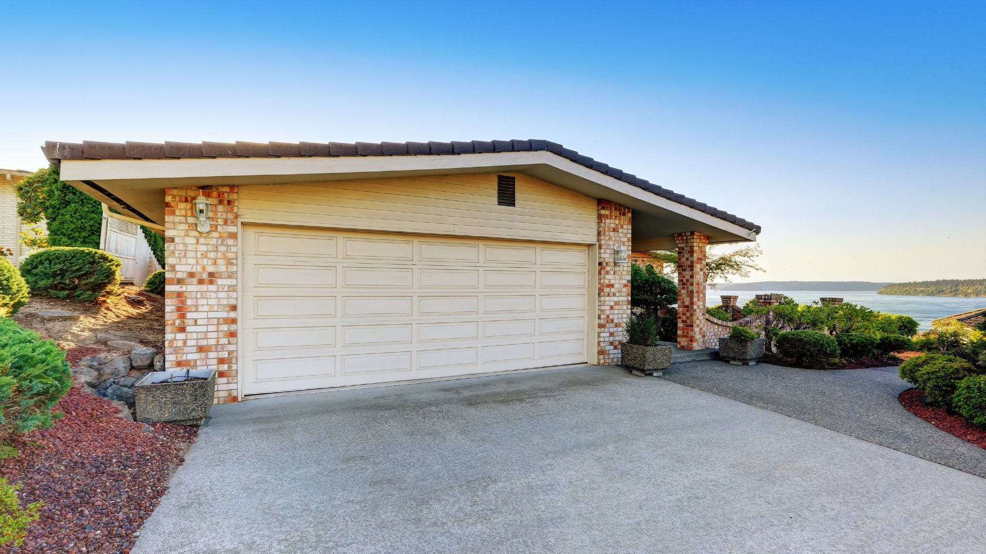 Small concrete driveway in front of a closed garage door.