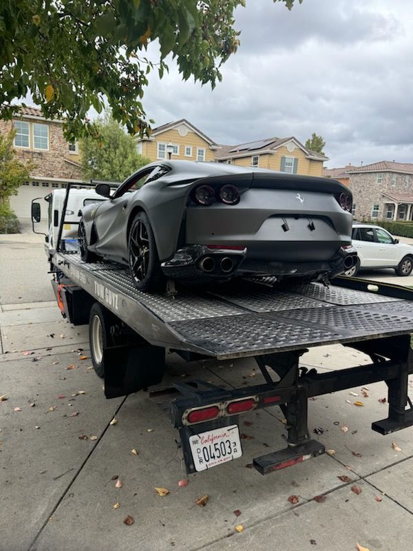 Sports car loaded on flatbed tow truck