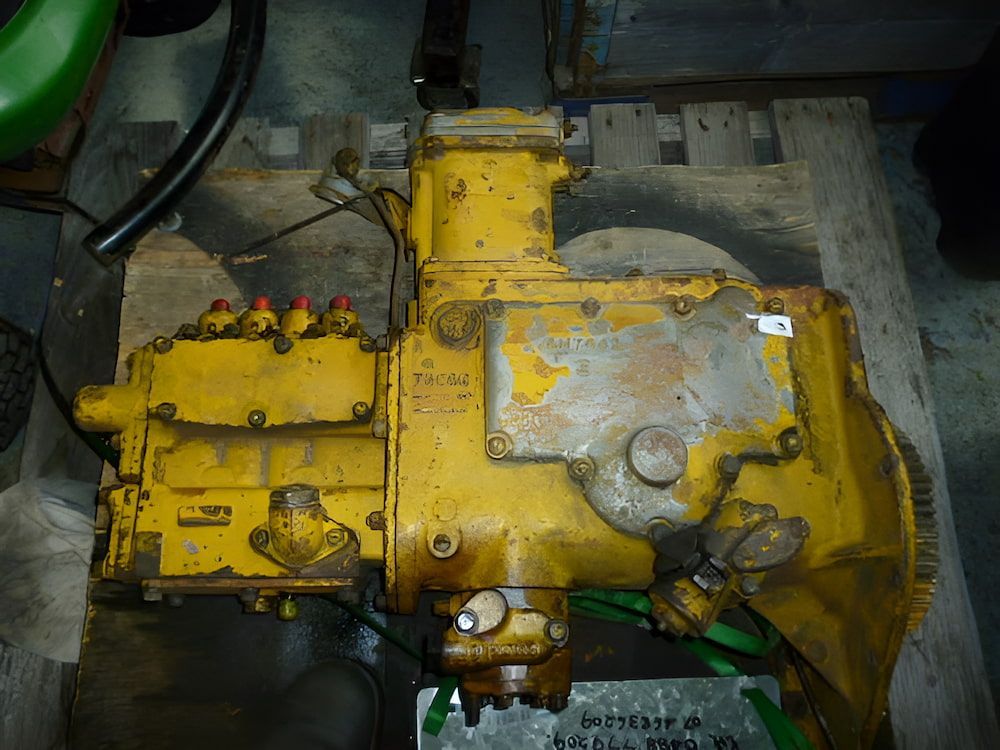 A Yellow Engine is Sitting on a Wooden Table — Whitsunday Diesel & Marine In Ayr, QLD