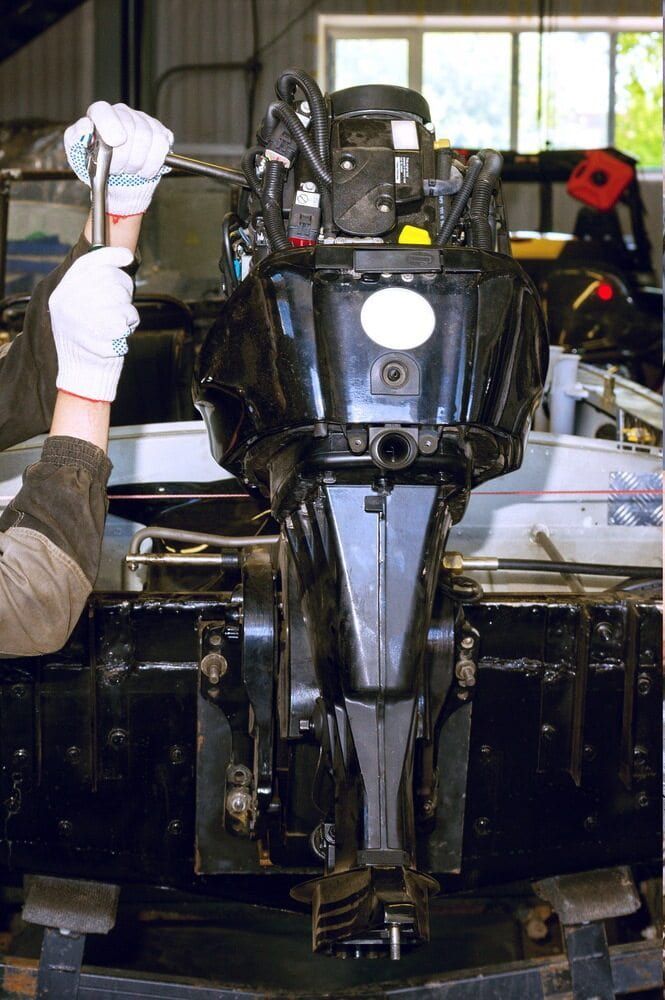 A Person is Working on a Boat Engine in a Garage — Whitsunday Diesel & Marine In Emerald, QLD