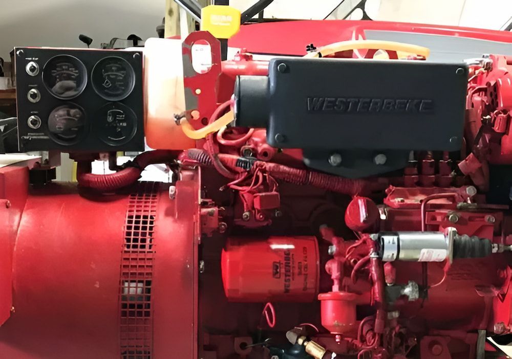 A Red Engine With a Filter on It is Sitting in a Garage — Whitsunday Diesel & Marine In Emerald, QLD