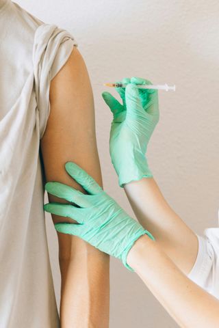 Needle injecting a vaccine